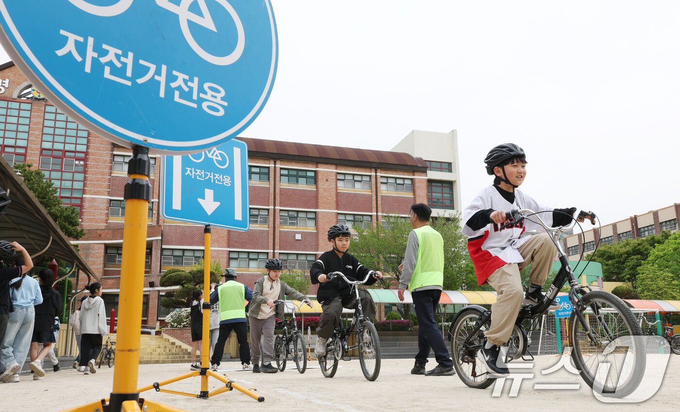 본문 이미지 - 자전거의 날인 22일 경기 수원시 권선구 명당초등학교에서 열린 '2026년 찾아가는 자전거&PM(개인형 이동장치) 안전교육'에서 학생들이 교통표지판과 법규 등 안전 주행 방법을 '자전거와환경 사회적협동조합' 관계자들에게 교육받고 있다. 2026.4.22 ⓒ 뉴스1 김영운 기자