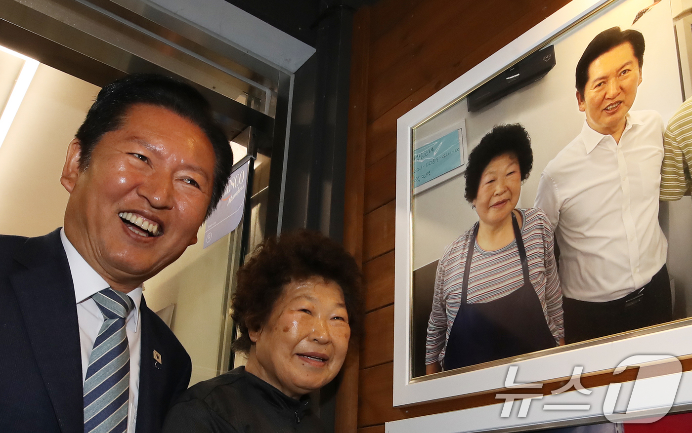 (통영=뉴스1) 윤일지 기자 = 정청래 더불어민주당 대표가 22일 경남 통영 통영중앙전통시장을 찾아 이전 시장 방문 때 만났던 상인과 환하게 웃고 있다. 2026.4.22/뉴스1