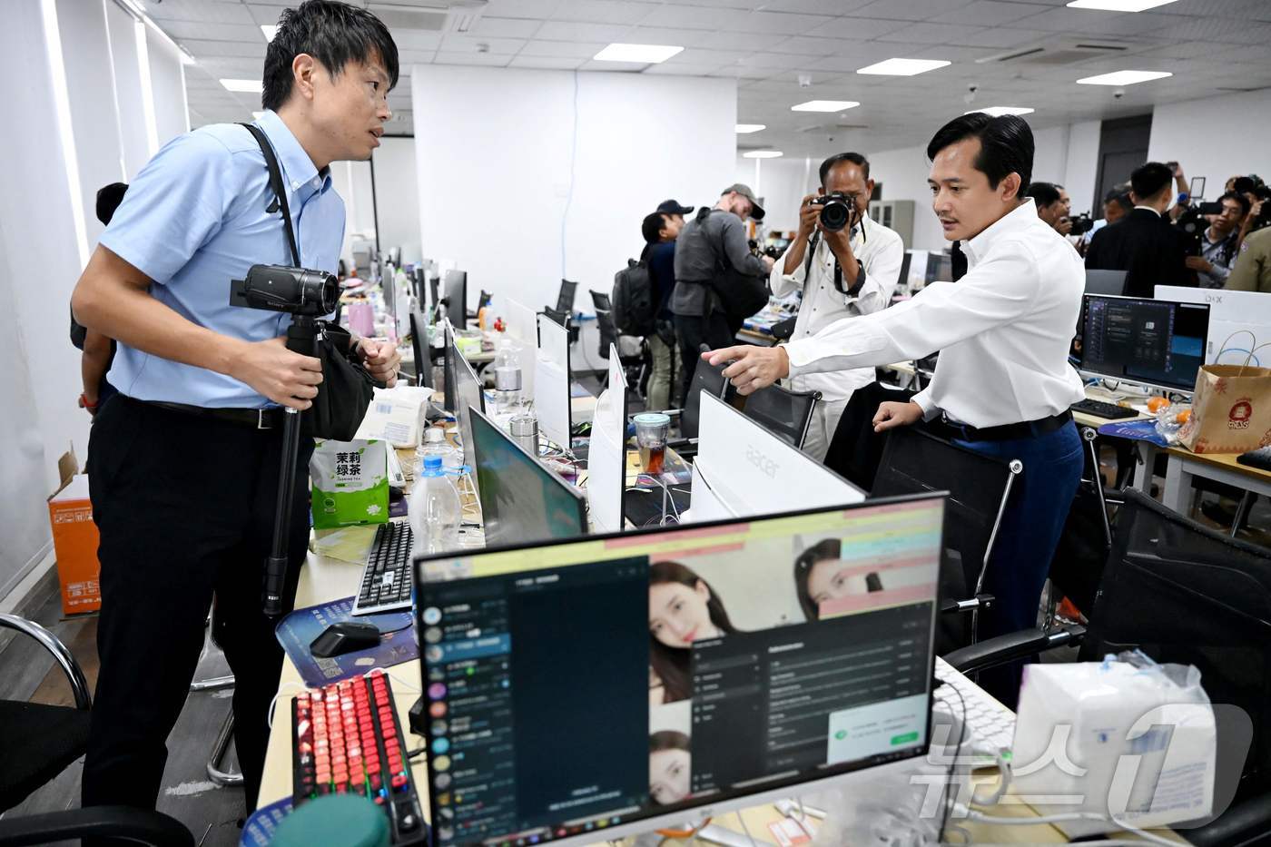 (프놈펜 AFP=뉴스1) 김경민 기자 = 텝 아스나릿 캄보디아 정보부 차관 겸 대변인이 3월 프놈펜 사이버 사기 센터에서 압수된 모니터를 살펴보고 있다. 2026.3.11ⓒ AFP …