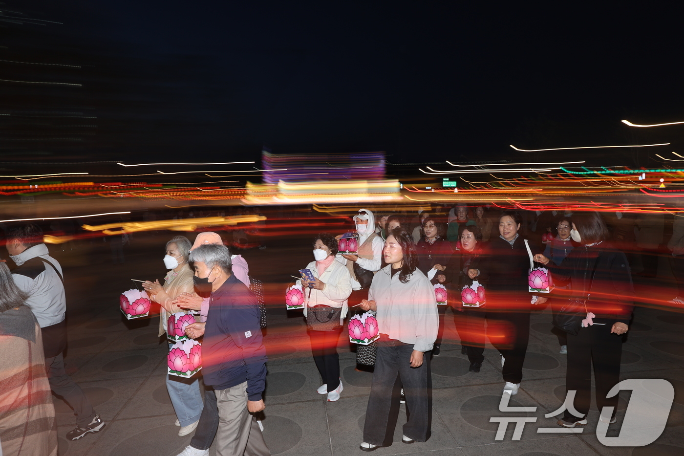 (서울=뉴스1) 안은나 기자 = 22일 오후 서울 종로구 광화문광장에서 열린 '평화와 화합의 보현사 탑등' 봉축점등식에서 참가자들이 탑돌이를 하고 있다. 2026.4.22/뉴스1