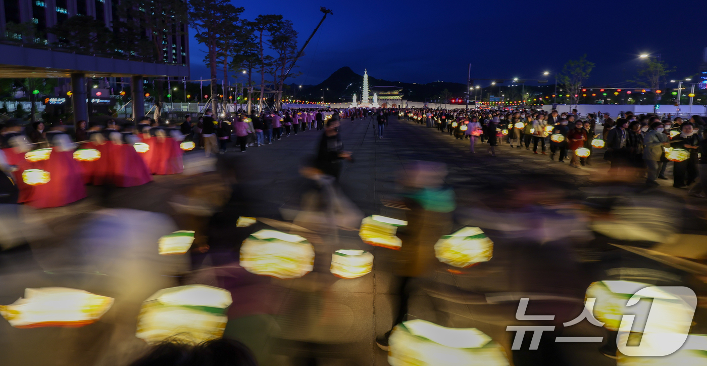 (서울=뉴스1) 안은나 기자 = 부처님 오신 날을 앞두고 22일 오후 서울 종로구 광화문광장에서 열린 '평화와 화합의 보현사 탑등' 봉축점등식에서 불자들이 탑돌이를 하고 있다. 2 …