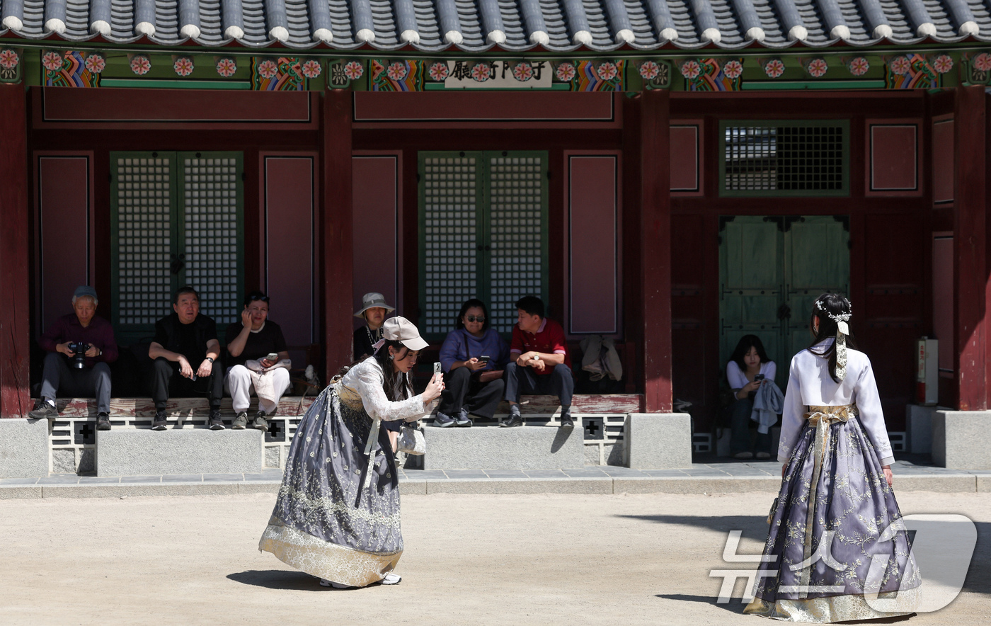 (서울=뉴스1) 임지훈 인턴기자 = 서울 낮 최고 기온이 26도까지 올라가는 등 초여름 날씨를 보인 24일 서울 종로구 경복궁을 찾은 외국인 관광객들이 한복을 입고 뜨거운 햇빛 아 …