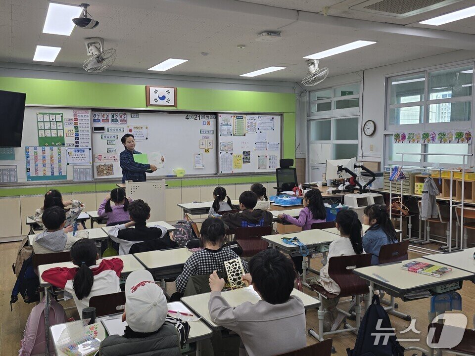 본문 이미지 - '리당맘' 학부모 회원이 학생들을 상대로 그림책을 읽어주고 있다.(전남교육청 제공, 재판매 및 DB금지)/뉴스1  