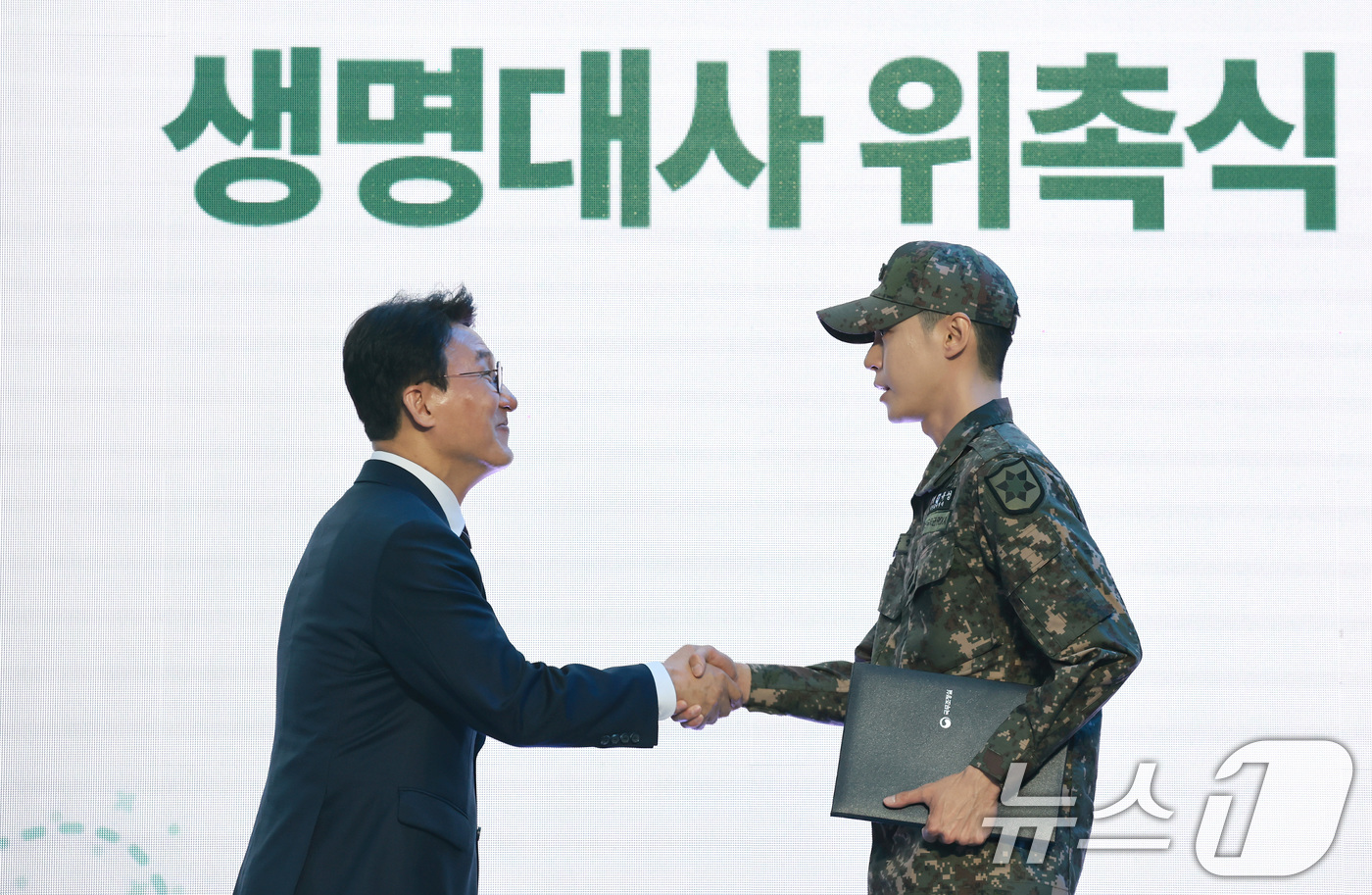 (서울=뉴스1) 임세영 기자 = 김민석 국무총리가 24일 서울 중구 청계광장에서 열린 천명지킴 발대식에서 NCT 도영에게 생명대사 위촉장을 수여하고 있다. 2026.4.24/뉴스1 …