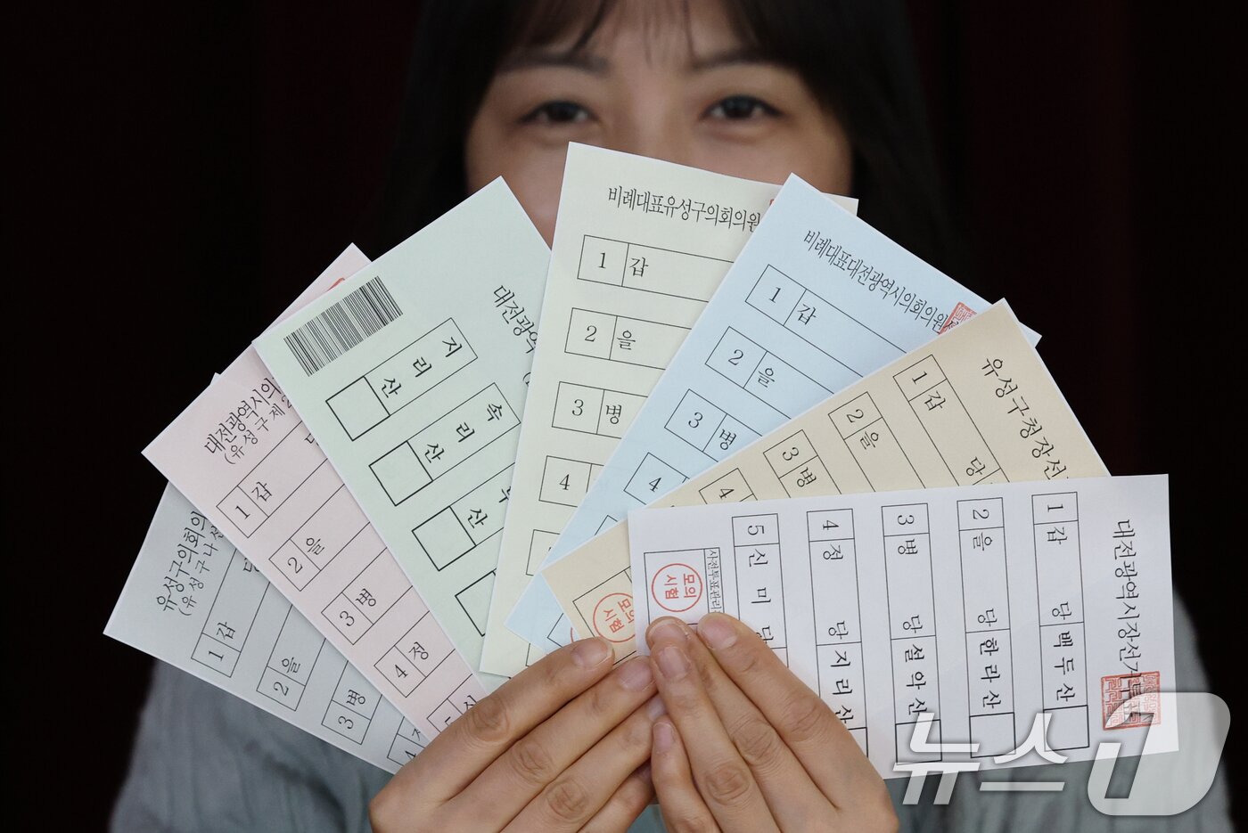 본문 이미지 - 28일 대전 유성구 어은중학교에서 대전시선관위 직원들이 제9회 전국동시지방선거 사전투표 제1차 모의시험에서 투표용지를 보이고 있다. 2026.4.28 ⓒ 뉴스1 김기태 기자