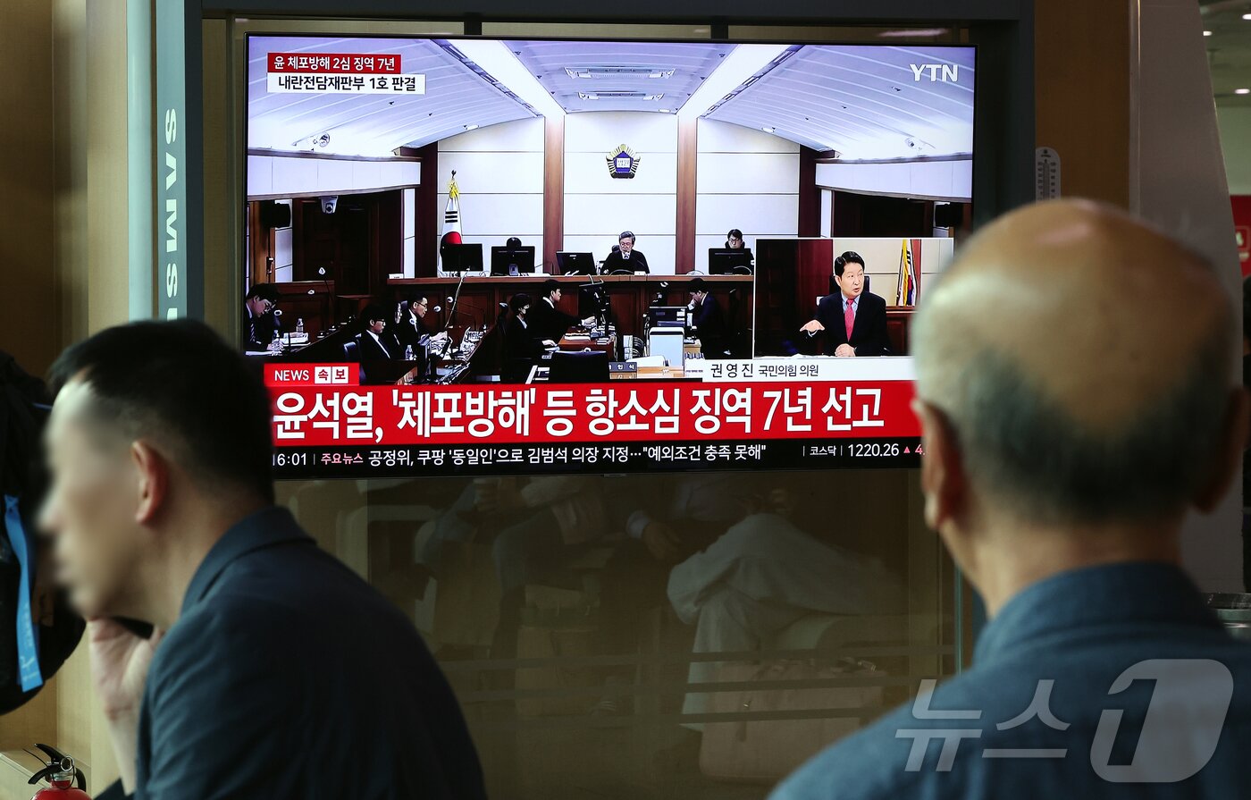 본문 이미지 - 29일 오후 서울시 용산구 한강대로 서울역 대합실에서 시민들이 특수공무집행방해, 직권남용 권리행사방해, 허위 공문서 작성 등의 혐의를 받는 윤석열 전 대통령의 항소심 선고 공판 생중계를 지켜보고 있다. 윤 전 대통령은 지난 1심 징역 5년 보다 2년 높은 징역 7년형을 선고 받았다. 2026.4.29 ⓒ 뉴스1 김진환 기자