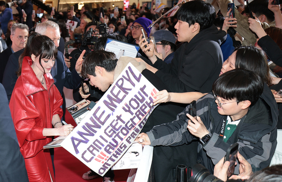 팬에게 사인해 주는 앤 해서웨이