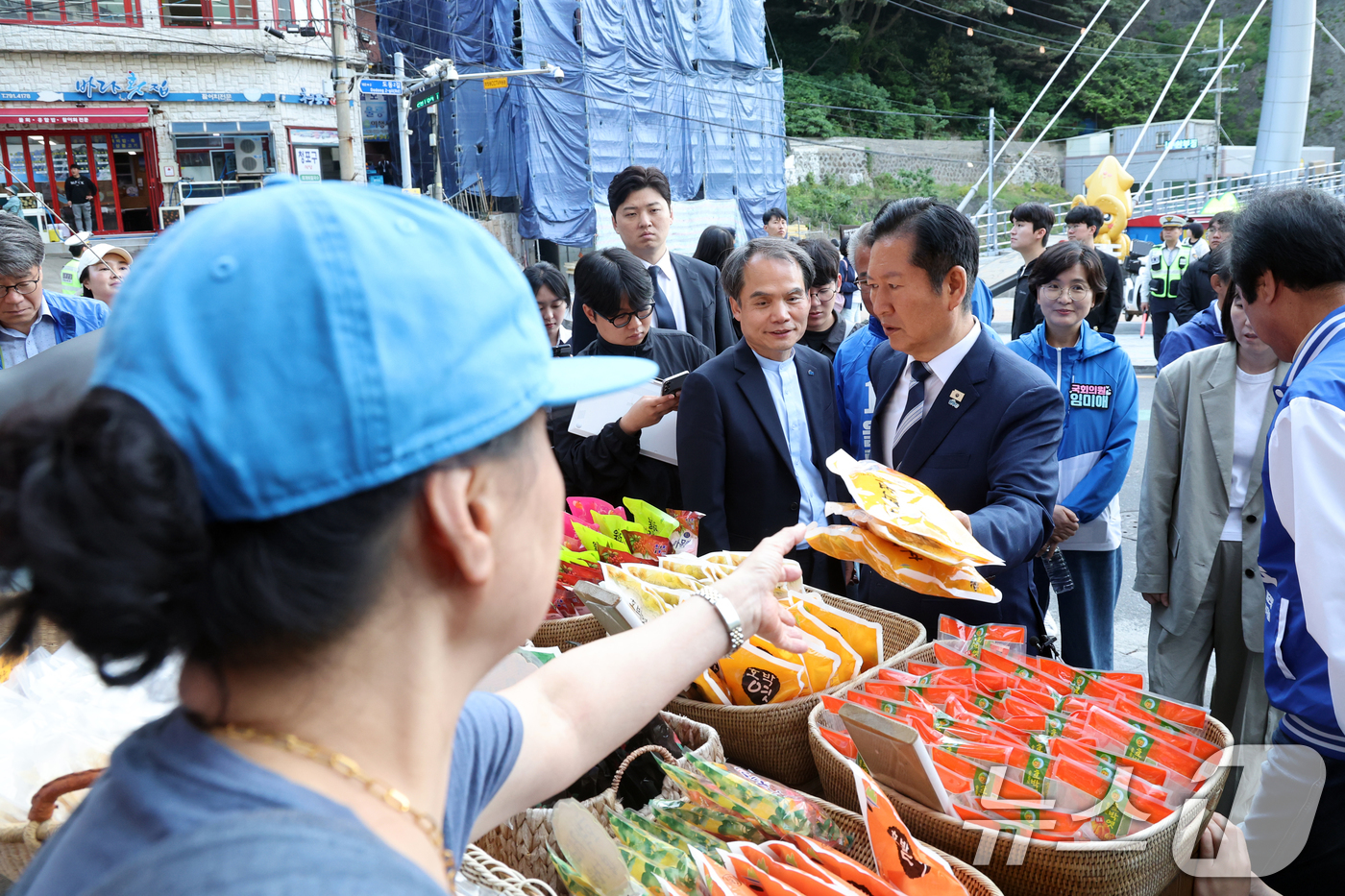 (울릉=뉴스1) 황기선 기자 = 정청래 더불어민주당 대표가 14일 오전 경북 울릉군 도동소공원 인근 상점에서 호박엿을 구입하고 있다.  2026.5.14/뉴스1