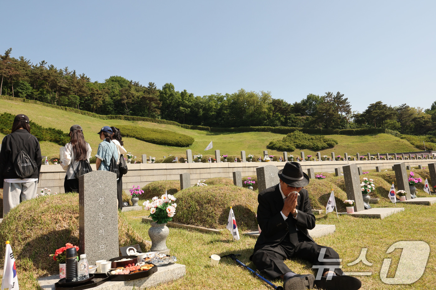 (광주=뉴스1) 박지현 기자 = 제 46주년 5·18민주화운동 기념일을 하루 앞둔 17일 노경운 열사 묘역 앞에서 동생을 그리워하며 차례상을 준비한 형이 눈물을 훔치고 있다. 20 …