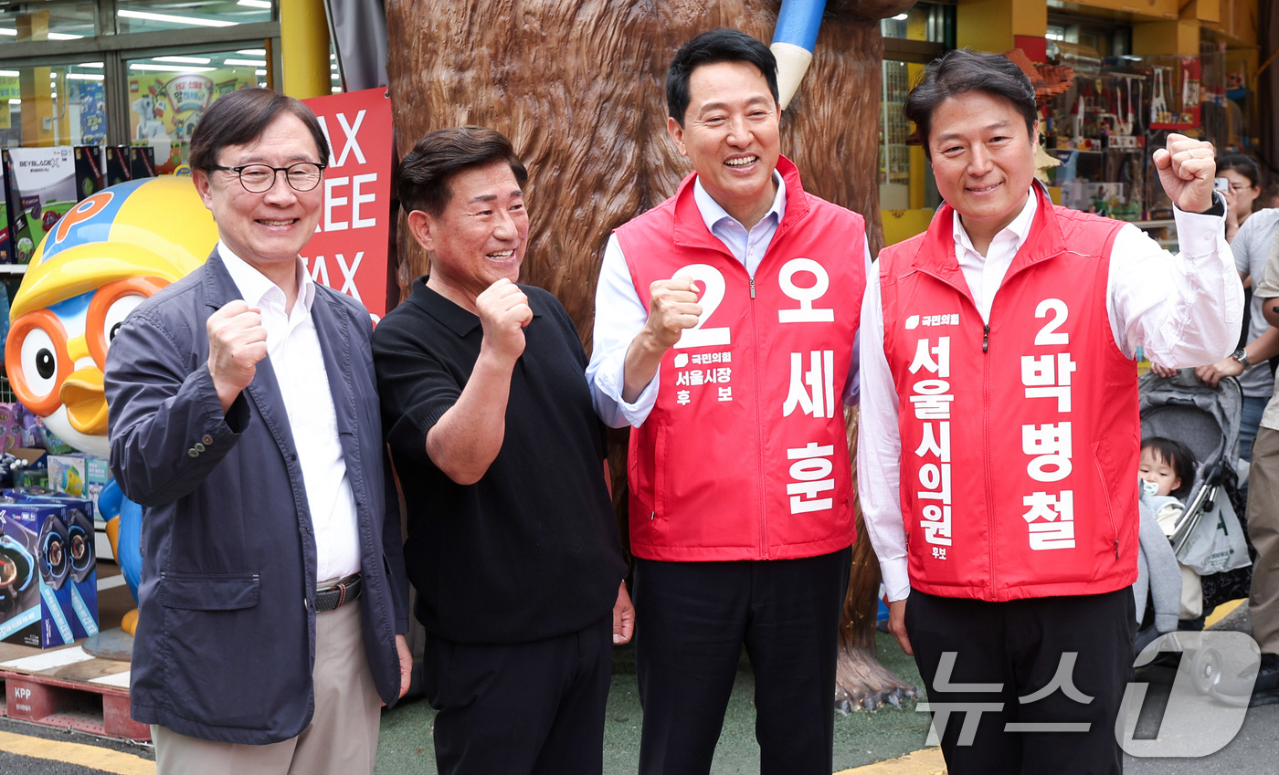 (서울=뉴스1) 임지훈 인턴기자 = 오세훈 국민의힘 서울시장 후보가 19일 오전 서울 종로구 창신동 문구완구거리에서 열린 ‘오세훈과 함께 걸어요’에서 상인들과 기념촬영을 하고 있다 …