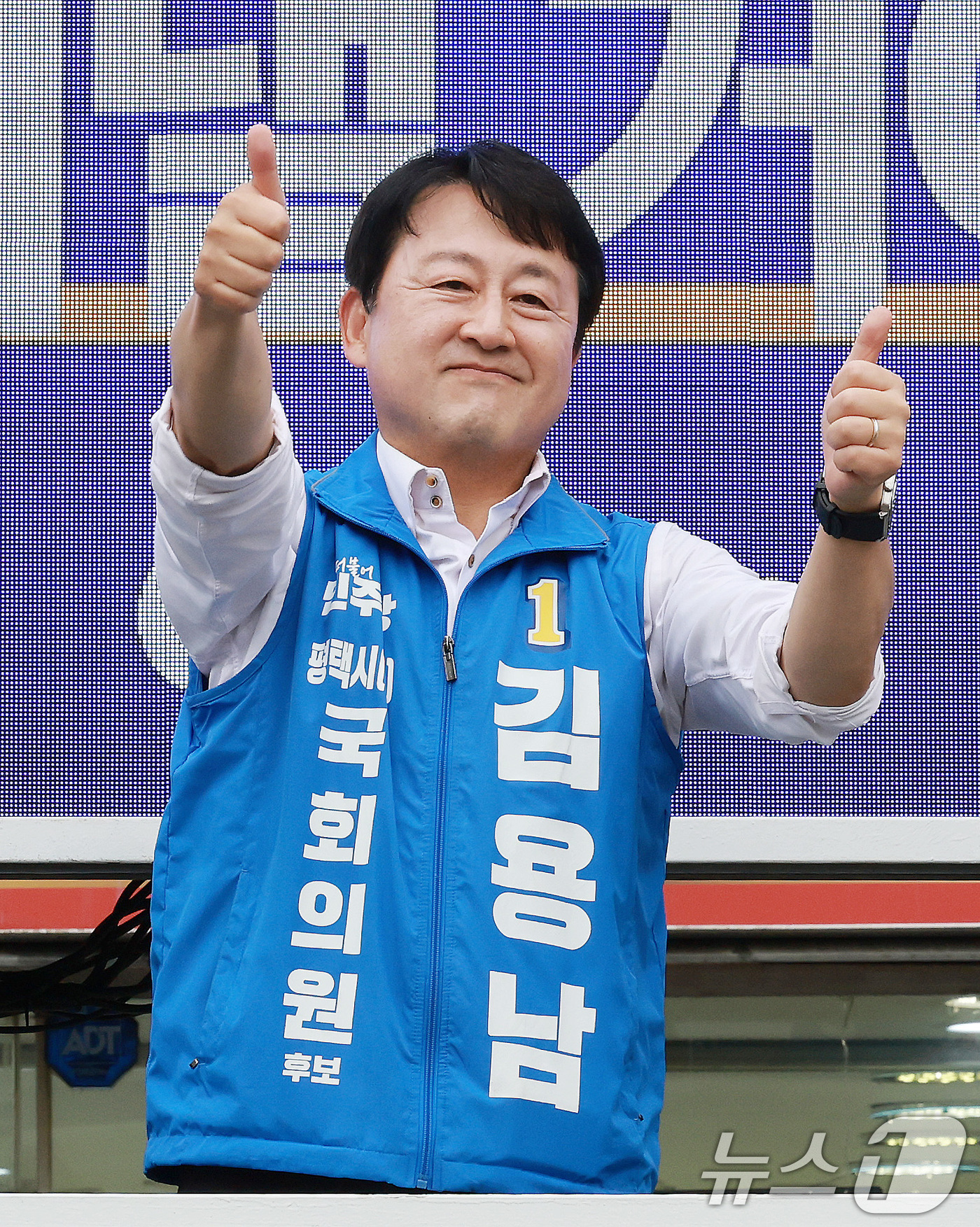 (평택=뉴스1) 임세영 기자 = 김용남 더불어민주당 경기평택을 국회의원 재선거 후보가 21일 경기도 평택시 안중시장 앞에서 열린 공식선거운동 출정식에서 엄지를 들어올리고 있다. 2 …