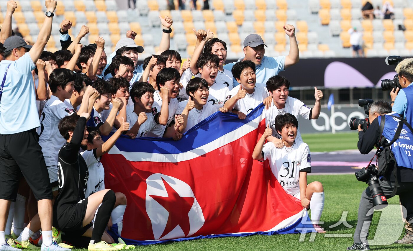 본문 이미지 - 23일 오후 경기 수원시 수원종합운동장에서 열린 2025-2026 아시아축구연맹(AFC) 여자 챔피언스리그(AWCL) 결승 도쿄 베르디의 경기에서 1-0으로 승리하며 사상 첫 정상에 오른 북한 내고향여자축구단 선수들이 인공기를 들고 기념촬영을 하고 있다. 2026.5.23 ⓒ 뉴스1 박지혜 기자