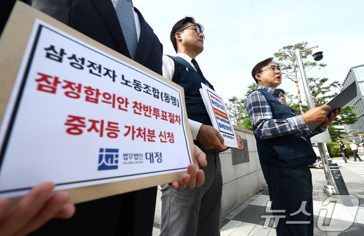 (수원=뉴스1) 김민지 기자 = 삼성전자 비반도체, DX 부문 직원 중심으로 구성된 삼성전자 노동조합 동행의 박재용 위원장을 비롯한 조합원들이 26일 오전 수원지방법원에서 2026 …
