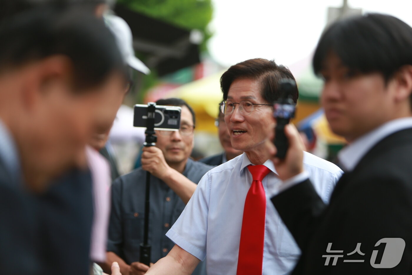본문 이미지 -  왼쪽부터 송김문수 전 고용노동부 장관이 충북 제천시민들과 인사를 나누고 있다. 2026.5.27/뉴스1 손도언 기자