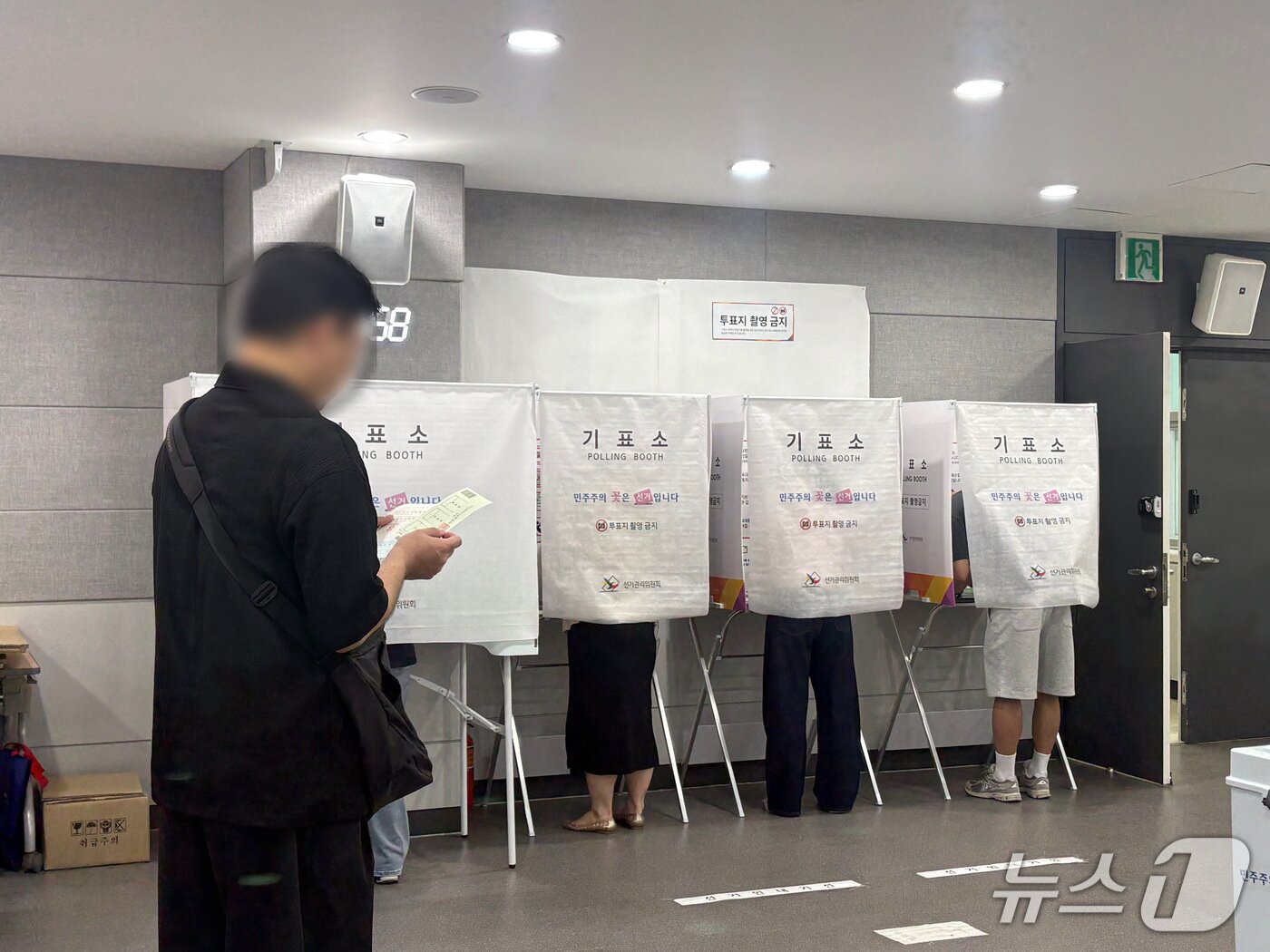 본문 이미지 - 29일 아침 8시쯤 부산 연제구청에 마련된 연산제2동사전투표소에 한 유권자가 기표소 앞에서 차례를 기다리고 있다. 2026.5.29 ⓒ 뉴스1 박서현 기자