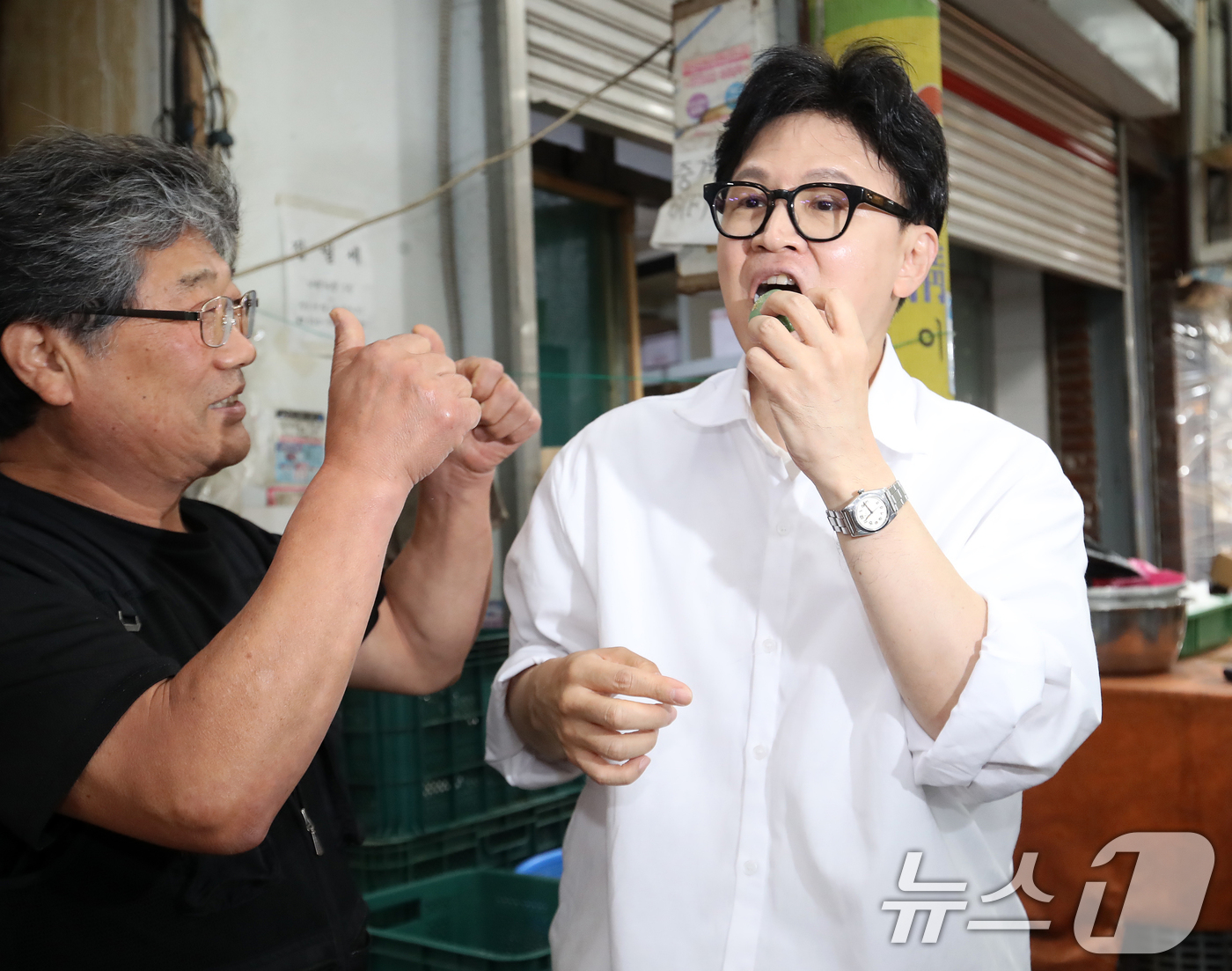 (부산=뉴스1) 윤일지 기자 = 한동훈 전 국민의힘 대표가 3일 부산 북구 구포시장을 찾아 떡을 맛보고 있다. 2026.5.3/뉴스1
