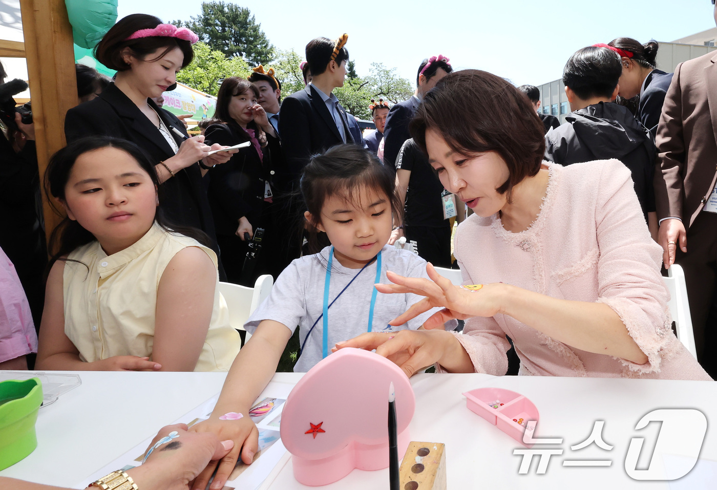 (서울=뉴스1) 허경 기자 = 김혜경 여사가 5일 청와대 녹지원에서 열린 2026 어린이날 초청행사에 참석한 어린이들과 함께 손등에 페이스 페인팅을 받고 있다. 2026.5.5/뉴 …