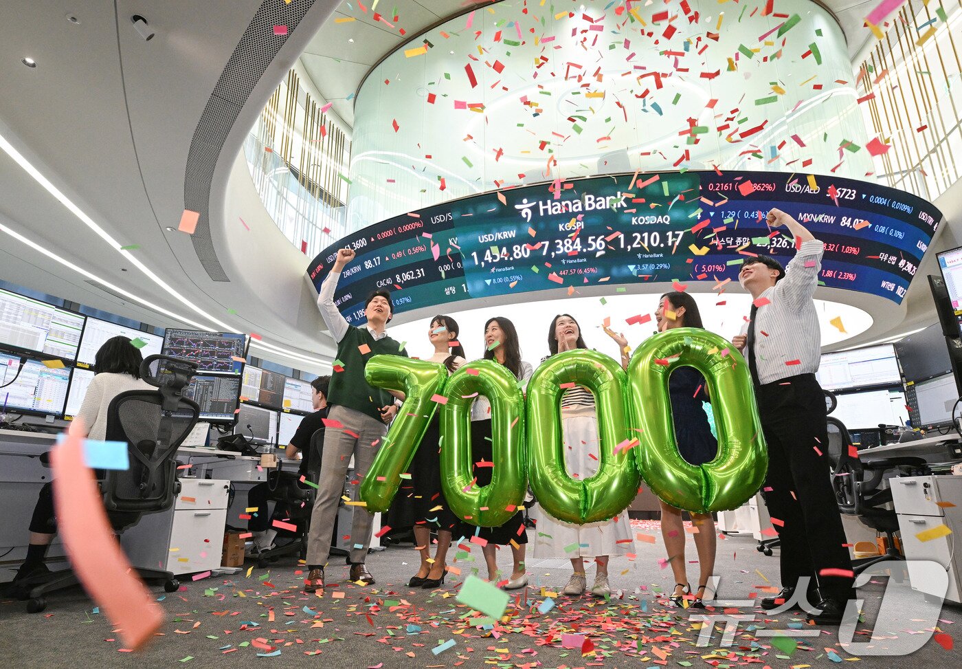 본문 이미지 - 코스피가 종가 기준 사상 처음 7000선을 돌파한 6일 서울 중구 하나은행 딜링룸에서 직원들이 축하 세레머니를 하고 있다. 이날 코스피는 전장보다 447.57포인트(6.45%) 오른 7,384.56에 장을 마쳤다. (공동취재) 2026.5.6 ⓒ 뉴스1 박지혜 기자