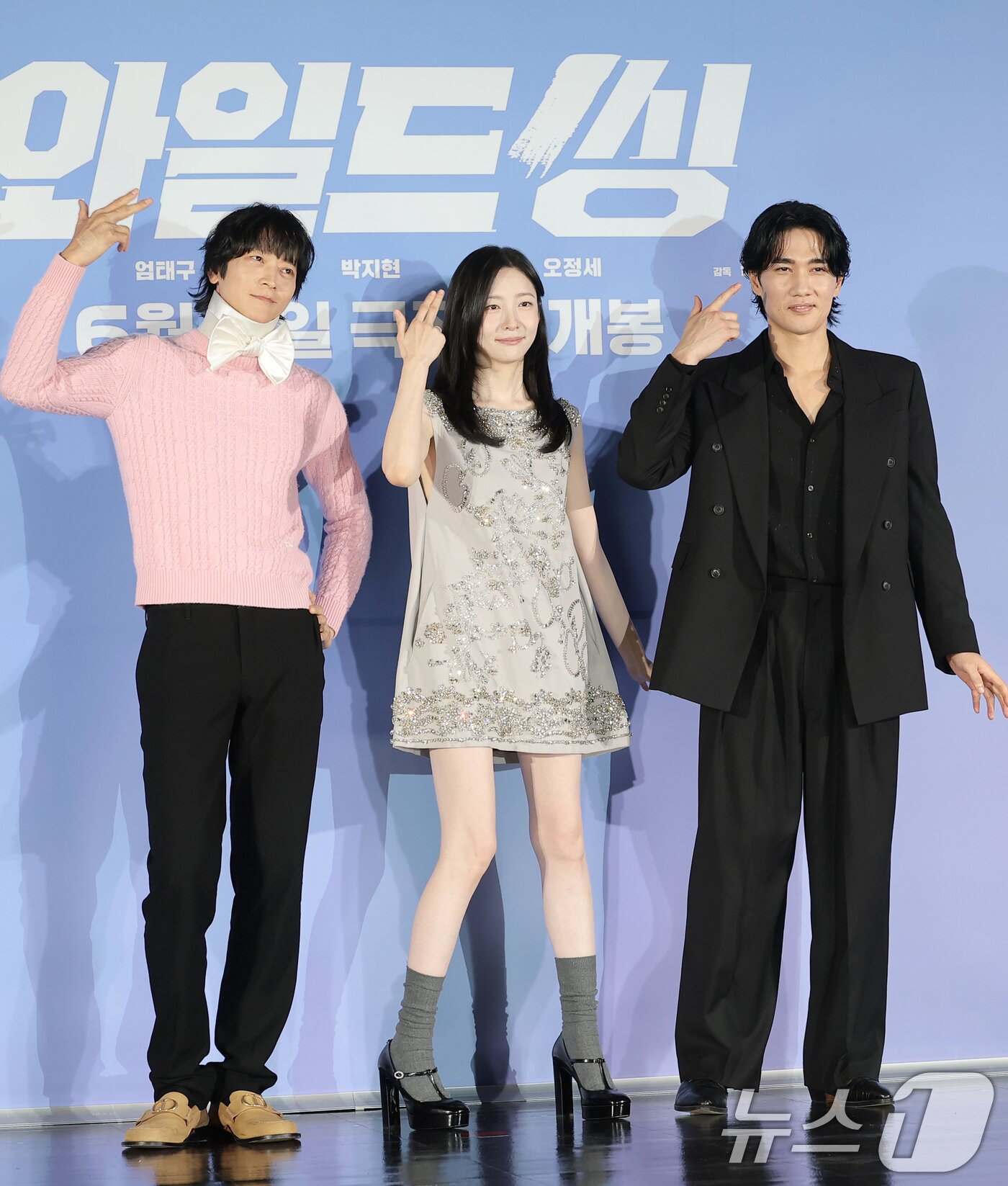본문 이미지 - 배우 강동원(왼쪽부터)과 박지현, 엄태구가 7일 서울 광진구 롯데시네마 건대입구에서 열린 영화 '와일드 씽'(감독 손재곤) 제작보고회에서 포즈를 취하고 있다. '와일드 씽'은 한때 가요계를 휩쓸었지만 예기치 못한 사건에 휘말려 하루아침에 해체된 3인조 혼성 댄스 그룹 트라이앵글이 20년 만에 찾아온 재기의 기회를 잡기 위해 무모한 도전을 벌이는 이야기다. 2026.5.7 ⓒ 뉴스1 권현진 기자