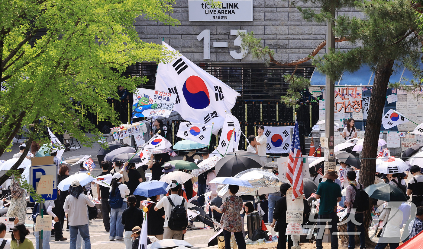 (서울=뉴스1) 이호윤 기자 = 제9회 전국동시지방선거 투표용지 부족 사태를 규탄하는 개표소 봉쇄 시위가 계속된 18일 서울 송파구 올림픽공원 핸드볼경기장 앞에서 시민들이 구호를 …