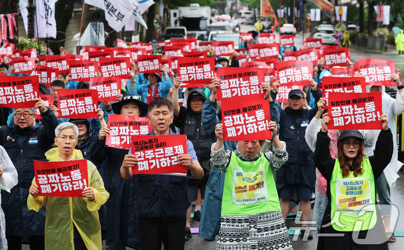 (서울=뉴스1) 오대일 기자 = 20일 오후 서울 종로구 청와대 사랑채 앞에서 열린 택시노동자 투쟁승리 공공운수노조 결의대회에서 참가자들이 '공짜노동·간주근로제 폐기'를 촉구하는 …