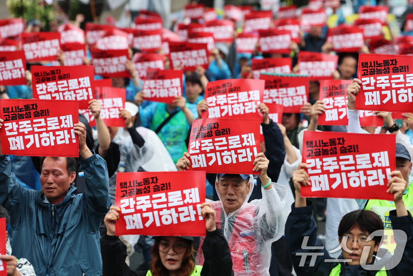 (서울=뉴스1) 오대일 기자 = 20일 오후 서울 종로구 청와대 사랑채 앞에서 열린 택시노동자 투쟁승리 공공운수노조 결의대회에서 참가자들이 '공짜노동·간주근로제 폐기'를 촉구하는 …
