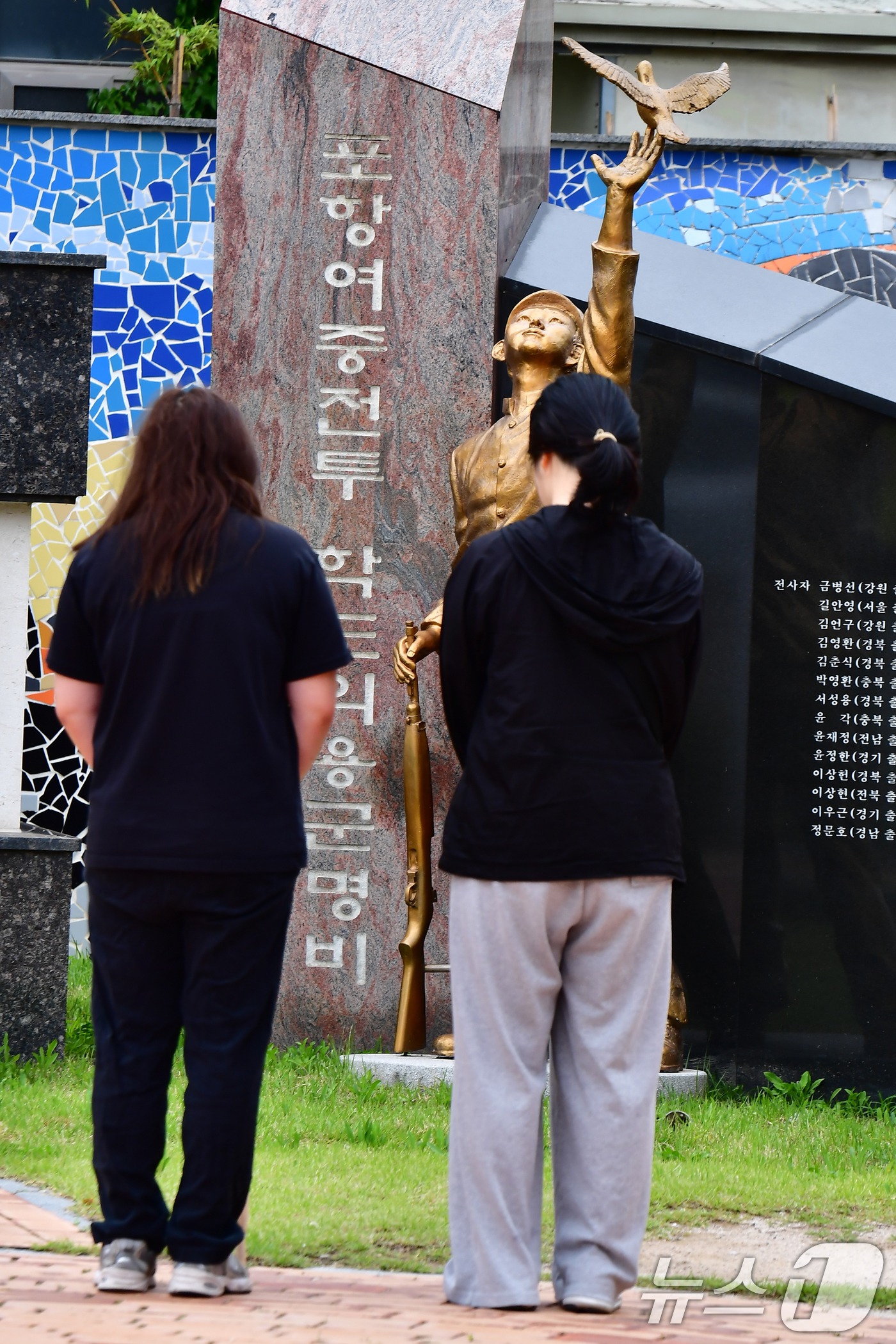 (포항=뉴스1) 최창호 기자 = 24일 경북 포항시 북구 포항여고 앞에 있는 학도의용군 추모공원을 찾은 시민들이 묵념하고 있다.