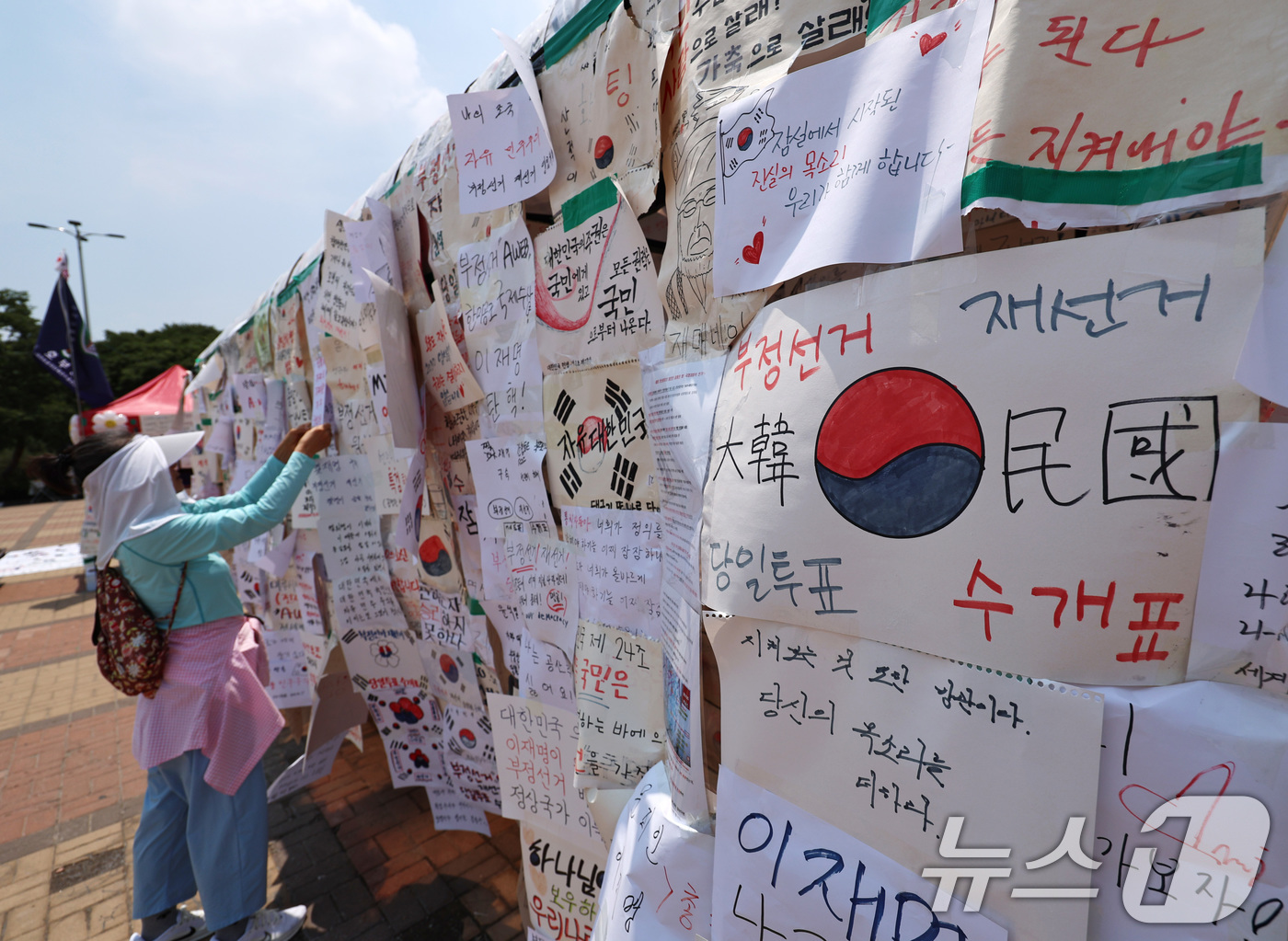 (서울=뉴스1) 구윤성 기자 = 6·3 지방선거 투표용지 부족사태로 인한 '잠실 봉쇄시위'가 25일째를 맞은 25일 서울 송파구 올림픽공원 핸드볼경기장 인근 매점 건물에 집회 참가 …