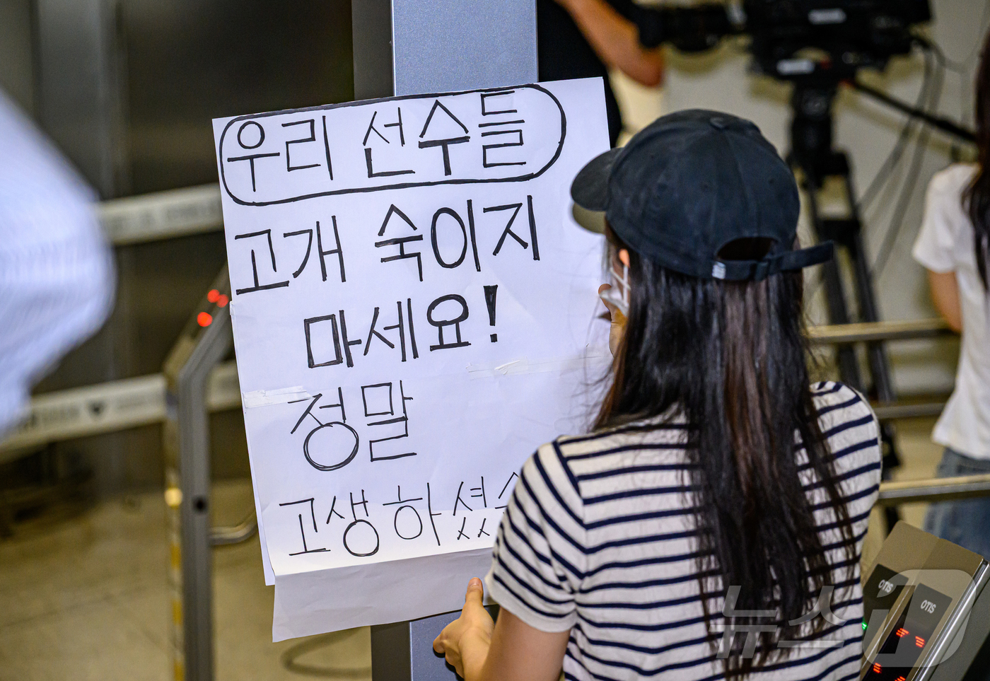 (인천공항=뉴스1) 안은나 기자 = 2026 북중미 월드컵을 마친 대한민국 축구대표팀이 30일 오전 인천국제공항 제2터미널에 도착한 가운데 한 여성 축구 팬이 '우리 선수들 고개 …