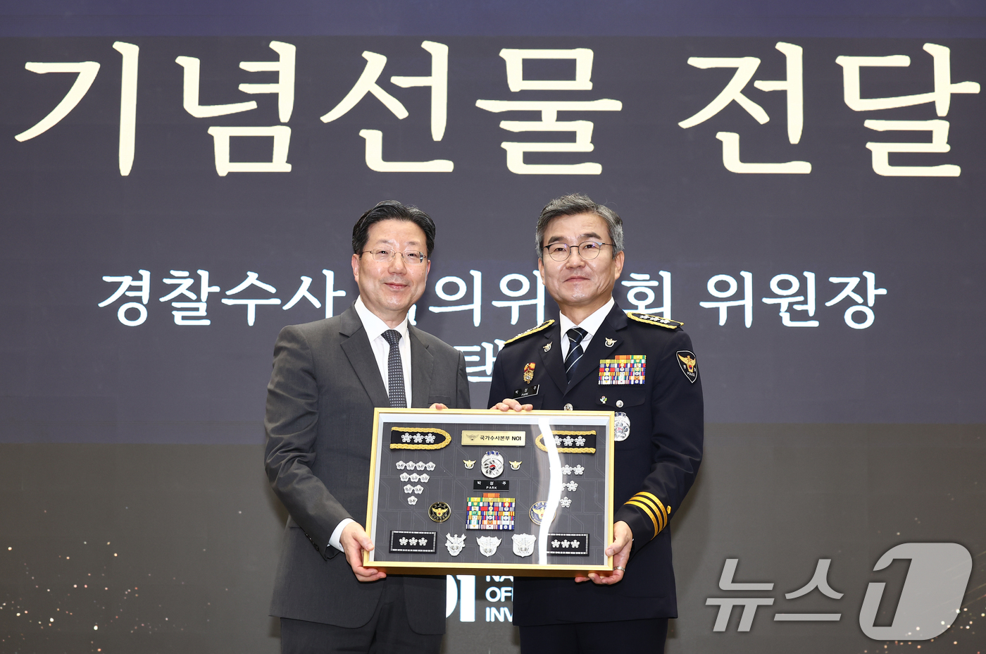 (서울=뉴스1) 김민지 기자 = 박성주 경찰청 국가수사본부장이 30일 오후 서울 서대문구 경찰청에서 열린 퇴임식에서 김선택 경찰수사심이위원장으로부터 기념선물을 전달 받은 뒤 기념촬 …