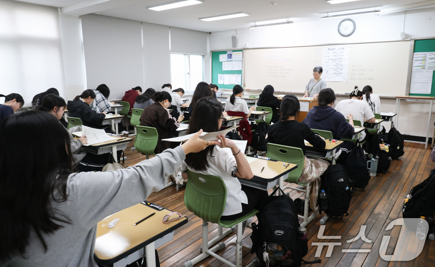 (서울=뉴스1) 사진공동취재단 = 2027학년도 대학수학능력 6월 모의평가일인 4일 오전 서울 마포구 서울여고에서 수험생들이 1교시 국어 영역 시험을 앞두고 시험지를 받고있다. 2 …