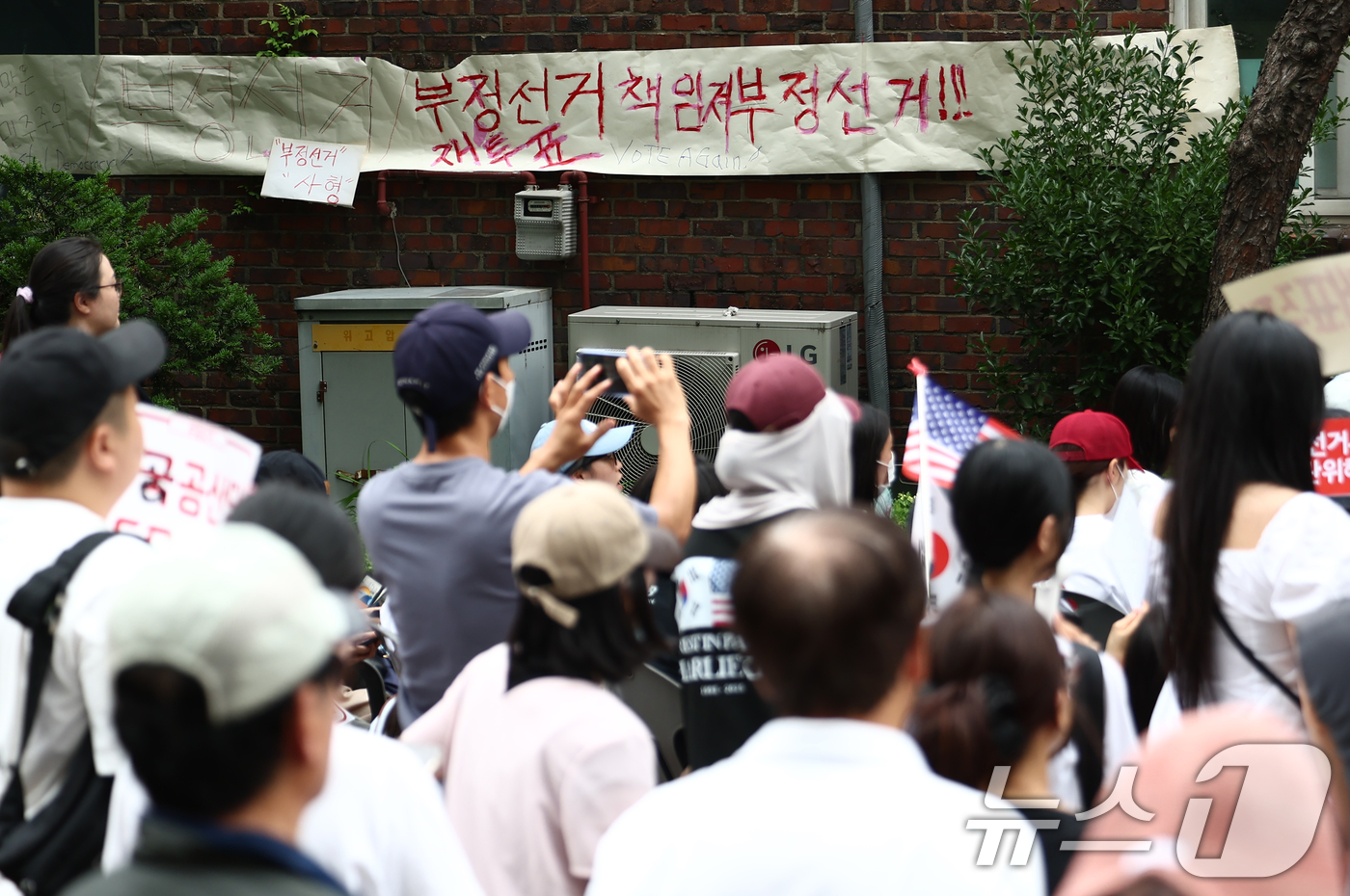 (서울=뉴스1) 김민지 기자 = 4일 오전 제9회 전국동시지방선거 및 국회의원 재·보궐선거 투표함 이송이 지연되고 있는 서울 송파구 잠실7동 제2투표소에 부정선거를 규탄하는 현수막 …