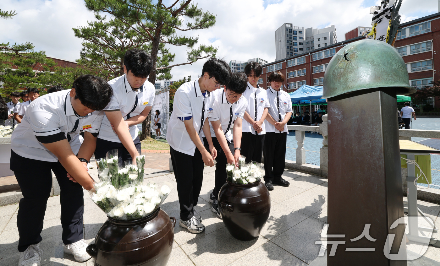 (수원=뉴스1) 김영운 기자 = 현충일을 하루 앞둔 5일 경기 수원시 팔달구 수원고등학교에서 열린 '6.25 참전 동문 학도병 추모 헌화식'에서 수원중·고등학교 학생들이 6.25 …