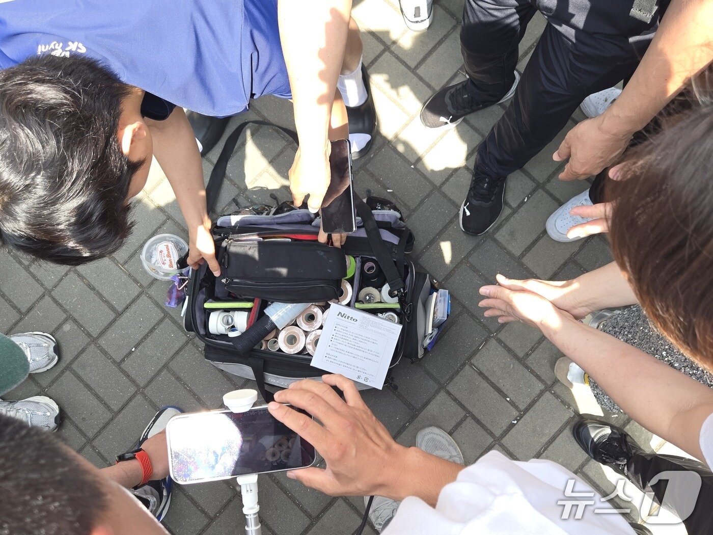 본문 이미지 - 8일 서울시 송파구 올림픽공원 핸드볼 경기장에서 핸드 여성 유소년 국가대표팀 선수가 소지품 검사를 강요하는 시위자들에게 둘러싸여 가방을 열고 있다. 2026.06.08/ⓒ 뉴스1 김범수 기자