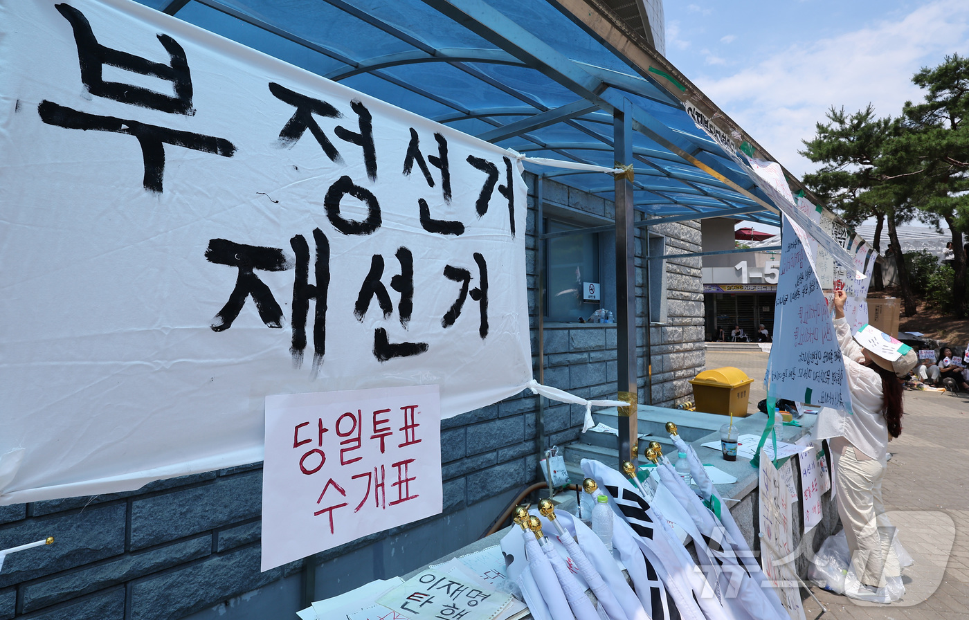 (서울=뉴스1) 김성진 기자 = 제9회 전국동시지방선거 투표용지 부족 사태에 반발한 시민들이 9일 서울 송파구 올림픽공원 핸드볼경기장에 설치된 개표소 앞에서 재선거를 촉구하며 피켓 …