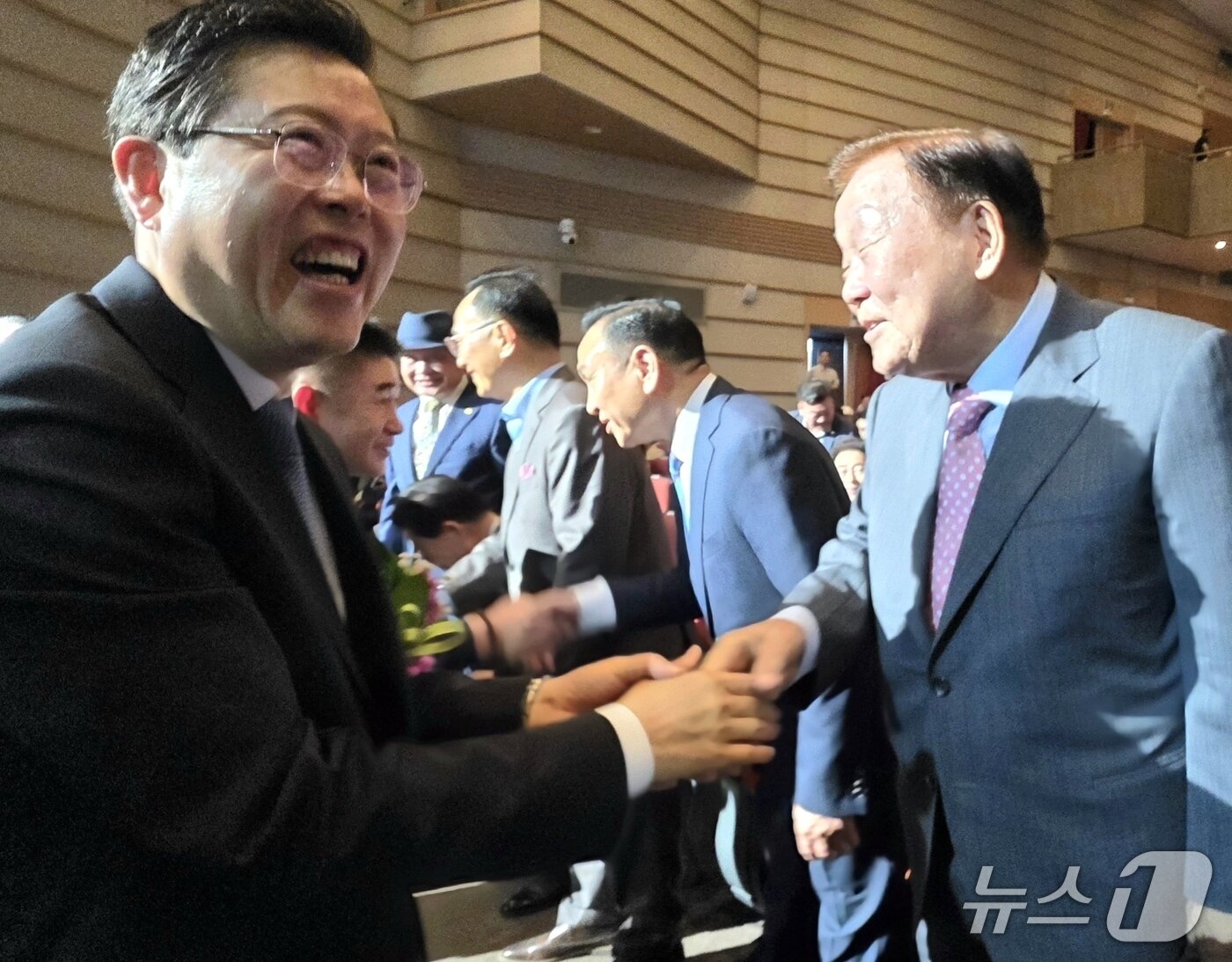 본문 이미지 - 장기수 천안시장이 1일 취임식에 참석한 성무용 전 천안시장과 인사한 뒤 웃고 있다. 2026.7.1. ⓒ 뉴스1 이시우 기자