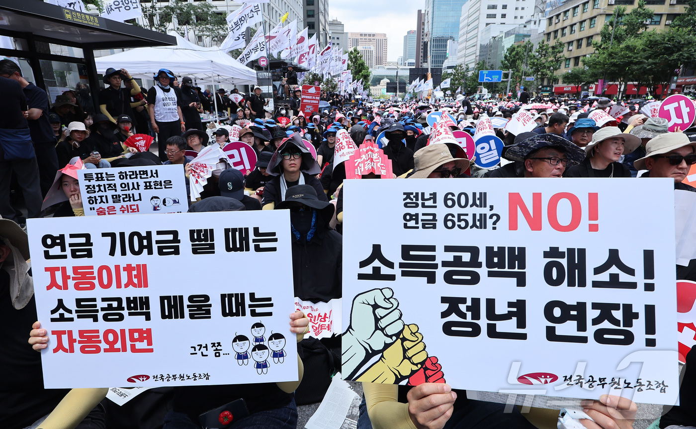 (서울=뉴스1) 김성진 기자 = 전국공무원노동조합 조합원들이 11일 서울 중구 숭례문 앞에서 열린 '7·11 공무원·교사 노동자대회'에서 손피켓을 들고 있다. 2026.7.11/뉴 …