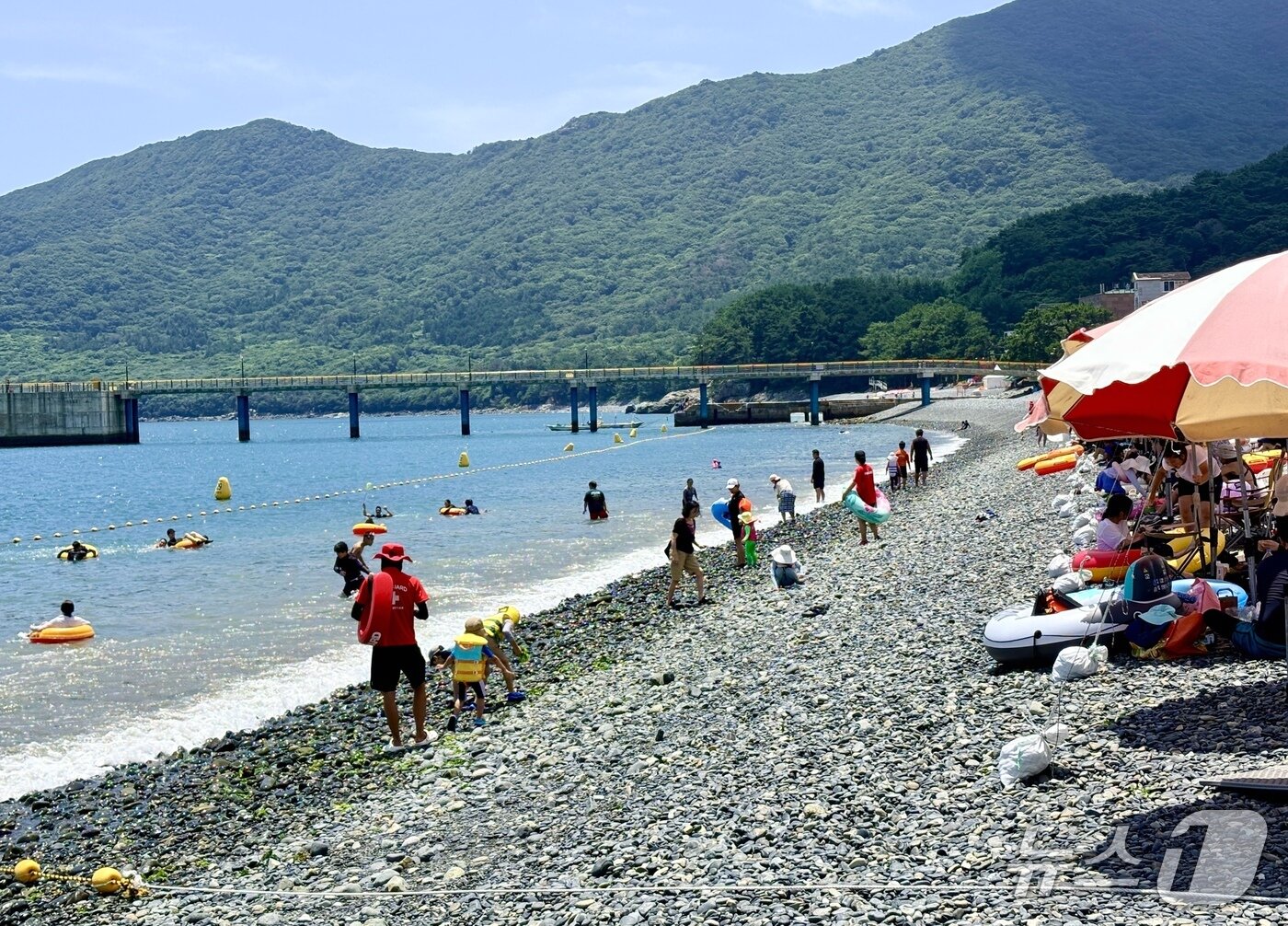 본문 이미지 - 12일 경남 거제 학동흑진주몽돌해수욕장을 찾은 피서객들이 물놀이를 즐기고 있다.2026.07.12/뉴스1 강미영기자