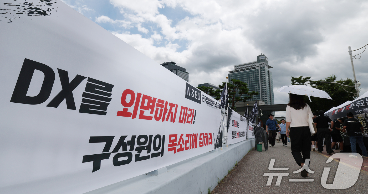 (수원=뉴스1) 김영운 기자 = 14일 경기 수원시 영통구 삼성전자 수원사업장 중앙문에 'DX부문 사기진작 및 보상마련 촉구 집회' 관련 현수막이 붙어있다. 2026.7.14/뉴스 …