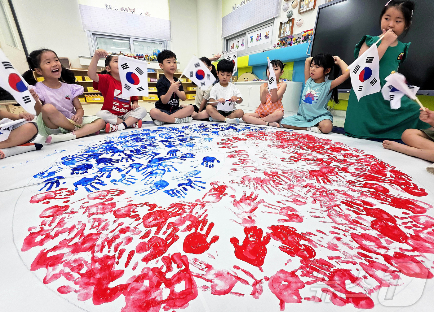 (전남광주=뉴스1) = 대한민국 헌법 공포를 기념하는 제헌절 78주년을 하루 앞둔 16일 전남광주통합특별시 북구청직장어린이집에서 아이들이 손도장을 찍어 완성한 태극 문양 앞에서 태 …