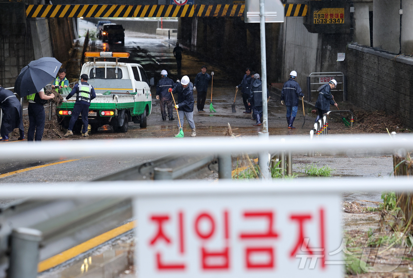 (서울=뉴스1) 김성진 기자 = 새벽부터 수도권에 집중호우가 내린 18일 서울 서대문구 증산교 인근에서 경찰과 구청 관계자들이 도로 정비를 하고 있다. 2026.7.18/뉴스1
