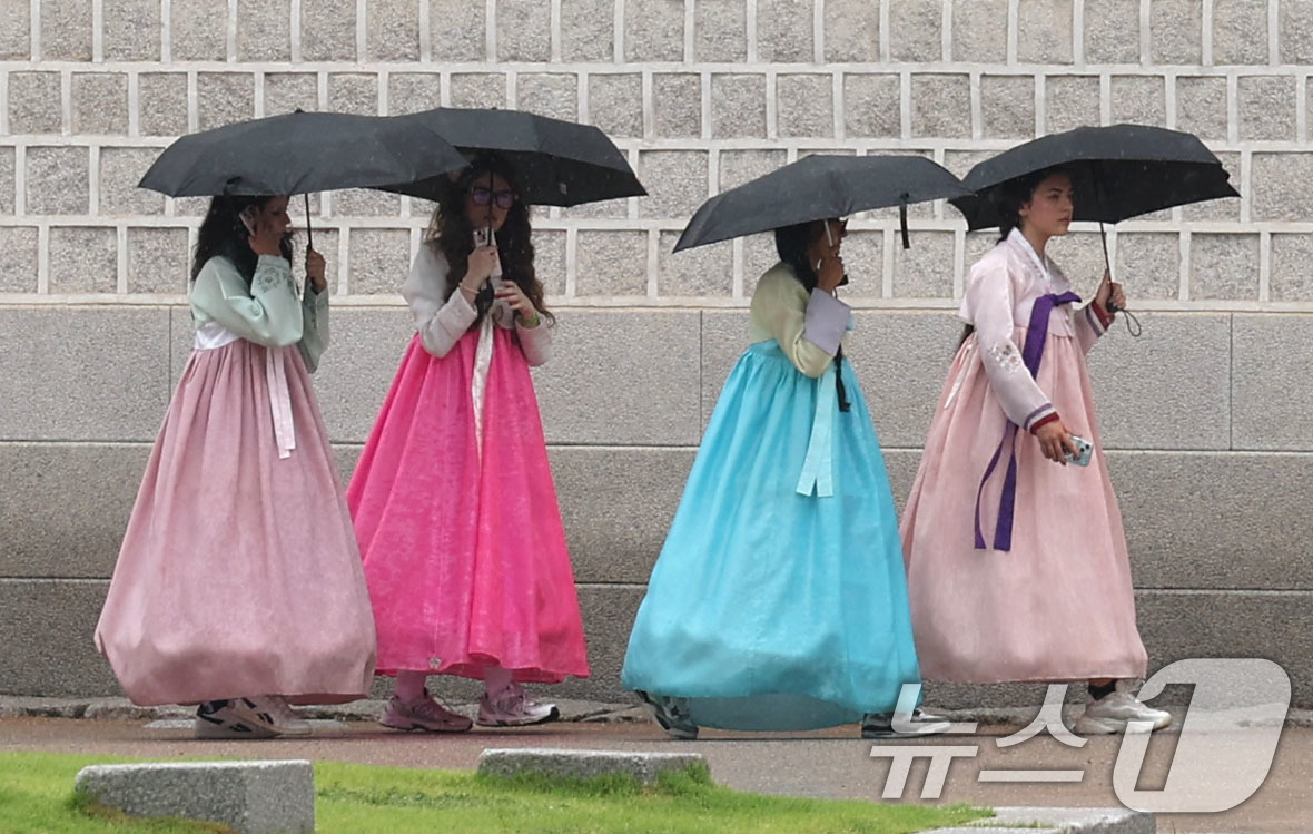 (서울=뉴스1) 이종수 기자 = 비가 내리는 20일 서울 중구 광화문 앞에서 외국인 관광객들이 우산을 쓰고 이동하고 있다. 2026.7.20/뉴스1