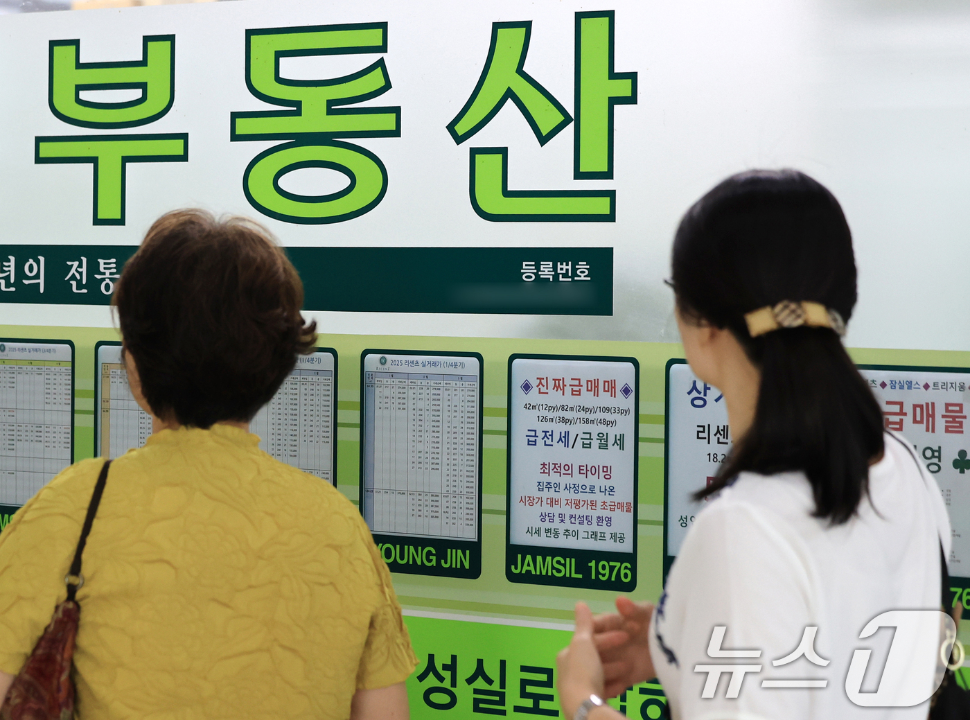 (서울=뉴스1) 이호윤 기자 = 이재명 정부의 부동산 정책 국민 대토론회가 개최된 23일 서울시내의 한 부동산에 게시된 안내문들을 시민들이 살펴보고 있다.이 대통령은 이날 토론회에 …