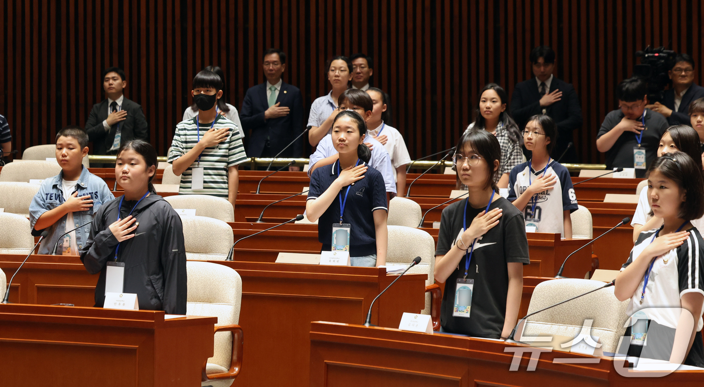 (서울=뉴스1) 황기선 기자 = 24일 오후 서울 여의도 국회에서 열린 제22회 대한민국 어린이 국회 본회의에서 어린이 국회의원들이 국민의례를 하고 있다.  2026.7.24/뉴스 …