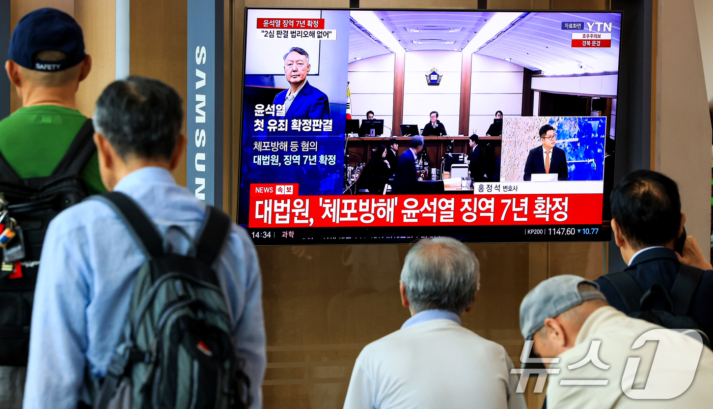 (서울=뉴스1) 이호윤 기자 = 9일 서울 중구 서울역 대합실에서 시민들이 윤석열 전 대통령의 고위공직자범죄수사처 체포방해 등 혐의 사건 상고심 선고 생중계를 지켜보고 있다.대법원 …
