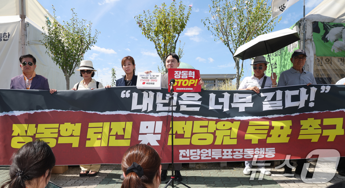 (서울=뉴스1) 황기선 기자 = 박인규 국민의힘 책임당원이 11일 오후 서울 여의도 국회 앞에서 장동혁 대표 퇴진 촉구를 위한 책임당원·일반시민 연판장을 들어보고이고 있다. 202 …