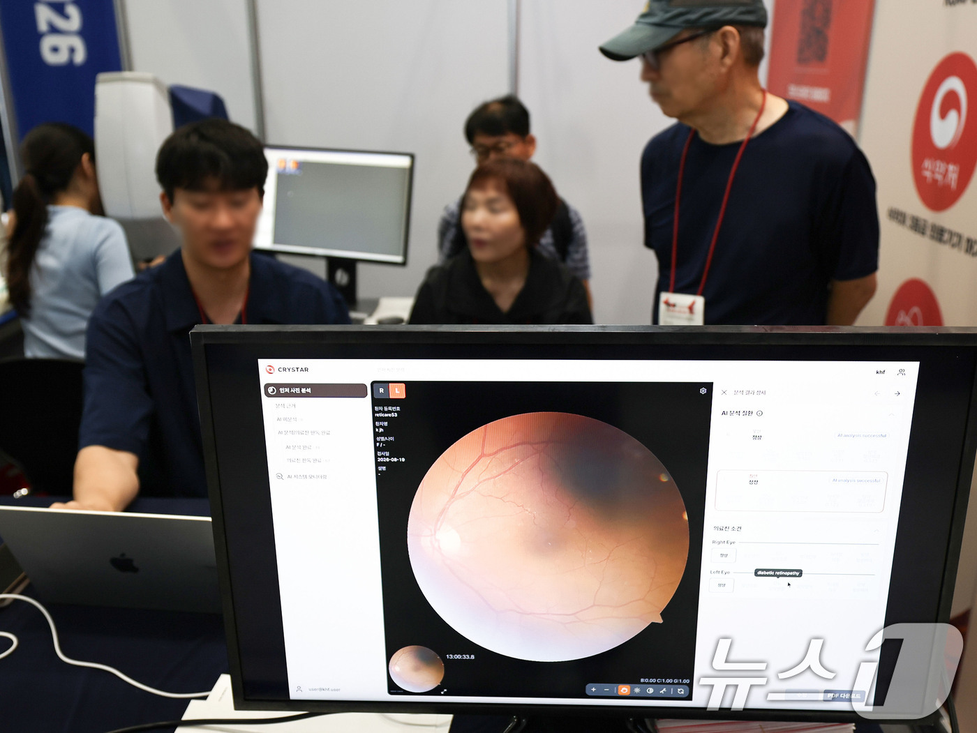 (서울=뉴스1) 이종수 기자 = 19일 서울 강남구 코엑스에서 열린 ‘2026 국제 병원의료산업 박람회’에서 관람객들이 AI 망막 분석기를 체험하고 있다. 2026.8.19/뉴스1 …