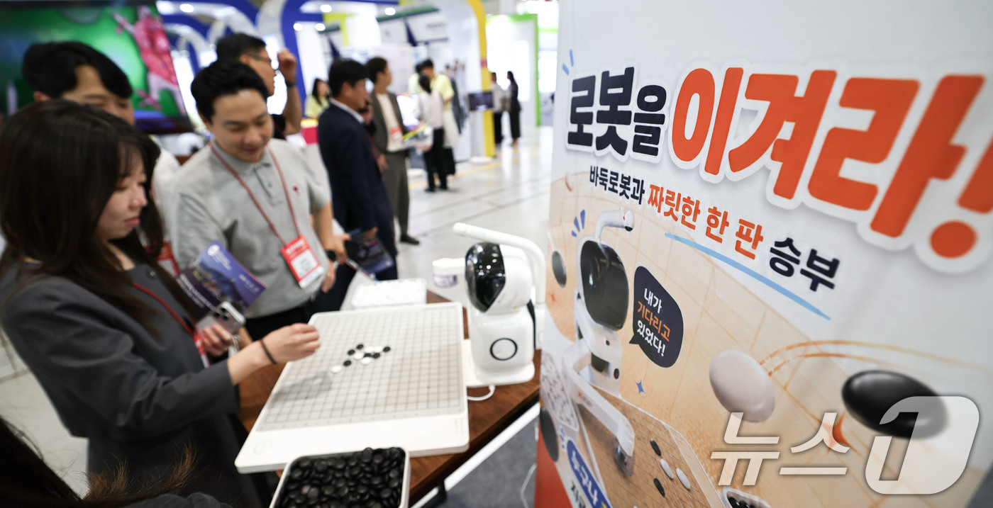 (서울=뉴스1) 이종수 기자 = 19일 서울 강남구 코엑스에서 열린 ‘2026 국제 병원의료산업 박람회’에서 관람객들이 바둑 로봇을 체험하고 있다. 2026.8.19/뉴스1