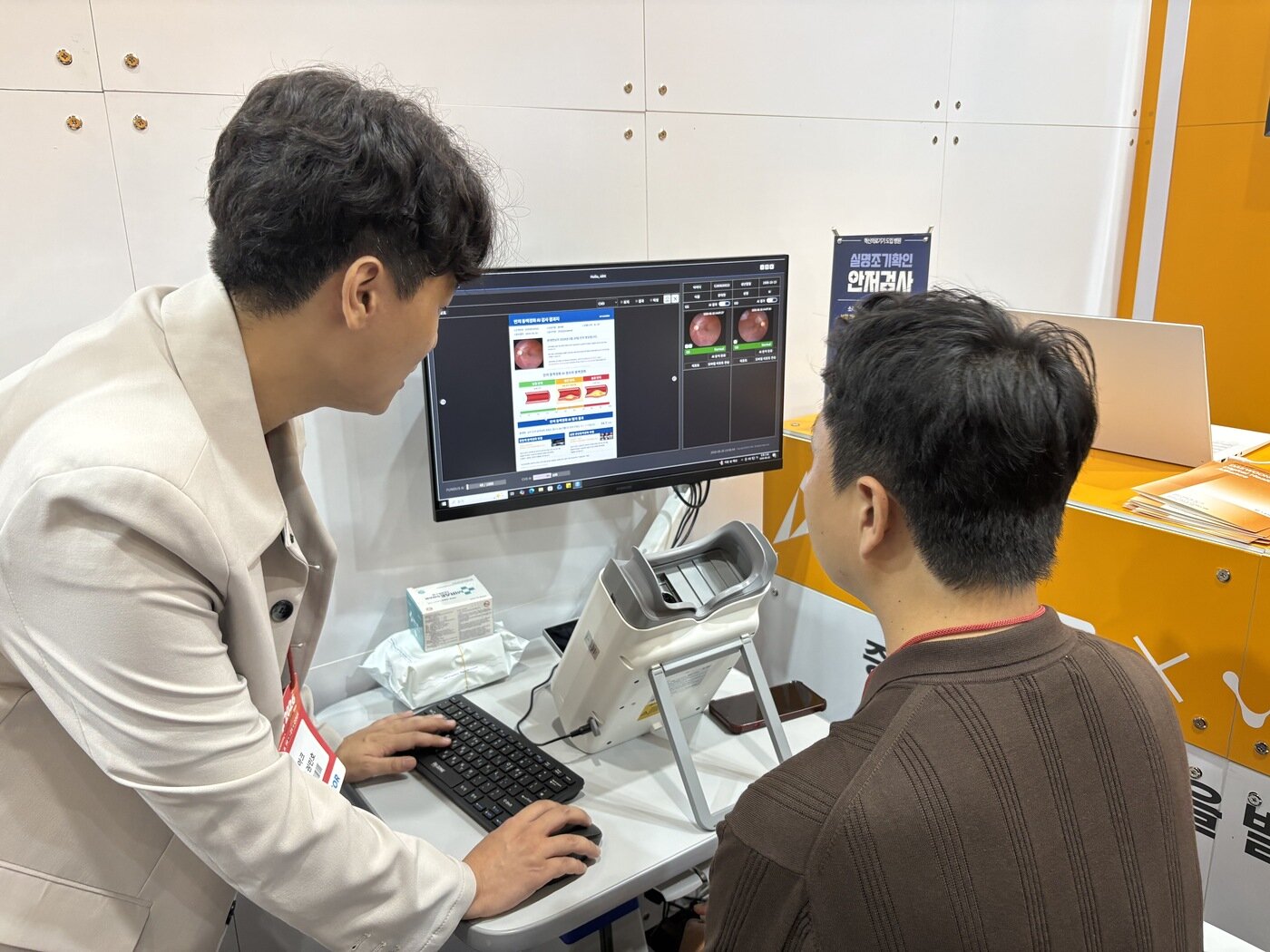 본문 이미지 - 기자가 대웅제약과 파트너십을 체결한 AI 의료 헬스케어 기업 아크의 AI 실명질환 진단 보조 솔루션을 체험하고 있다. (대웅제약 제공)