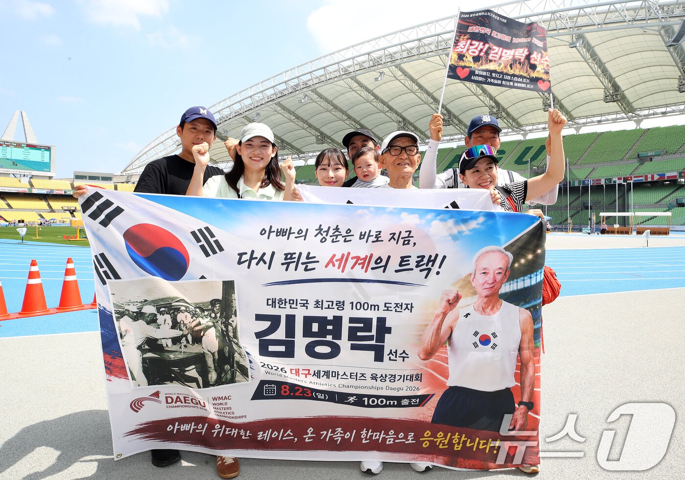 본문 이미지 - 23일 오전 대구스타디움에서 열린 '대구세계마스터즈육상경기대회' 남자 90세 100m 달리기 준결승에 출전한 국내 최고령 참가자 김명락 씨(90)가 결승선을 통과한 뒤 가족과 기념촬영을 하고 있다. ⓒ 뉴스1 공정식 기자